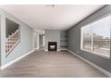 Living room with fireplace, wood-look floors, and staircase at 3802 Terrazzo Ave, Las Vegas, NV 89115