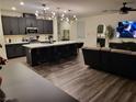 Modern kitchen with dark cabinetry, quartz countertops, and an island at 5773 Holbeche St, Las Vegas, NV 89113