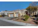 Single story house with a three-car garage and nicely landscaped yard at 5908 Aqua Verde St, North Las Vegas, NV 89031