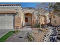 House exterior with a three-car garage and walkway to the front door at 5908 Aqua Verde St, North Las Vegas, NV 89031