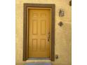 Yellow front door with a traditional six-panel design at 5915 Nuevo Leon St # 7, North Las Vegas, NV 89031