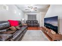 Living room with hardwood floors, leather couches and a large TV at 6287 Felicitas Ave, Las Vegas, NV 89122