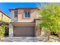 Two story home with brown garage door and stone accents at 712 Rogue Wave St, Las Vegas, NV 89138