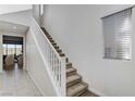 Staircase with white railing and carpeted steps at 712 Rogue Wave St, Las Vegas, NV 89138