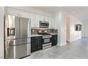 Stainless steel appliances and granite countertops in this modern kitchen at 7933 Grey Teal St, North Las Vegas, NV 89084