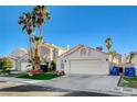 House exterior with a two-car garage and palm trees at 8113 Hercules Dr, Las Vegas, NV 89128