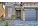 Two-story house featuring a black front door and stone accents at 87 Newton Ridge Way, Las Vegas, NV 89183