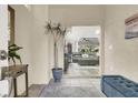 Bright entryway with tiled floors, a bench, and a view of the living room at 8753 Arawana Pl, Henderson, NV 89074