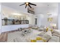 Open living room with a view of the kitchen and upper level at 9 White Tail Ct, Henderson, NV 89074