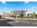 Luxury modern home with expansive windows and landscaped front yard at 9780 Solar Ave, Las Vegas, NV 89149