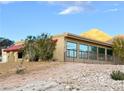 Tan house with large windows and a mountain backdrop at 1032 Morning Sun Way, Las Vegas, NV 89110