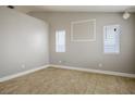 A spacious bedroom with a neutral color palette, tile flooring, and ample natural light at 1905 Rose Coral Ave, Las Vegas, NV 89106