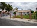 Cozy home featuring a manicured lawn and decorative brick pillar gated entrance at 1905 Rose Coral Ave, Las Vegas, NV 89106