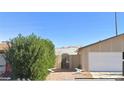 House exterior showing a side view with a tall hedge at 3614 Calmosa, Las Vegas, NV 89103