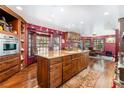 Gourmet kitchen with granite island, stainless steel appliances, and dark wood cabinets at 362 Rainbow Canyon Blvd, Las Vegas, NV 89124