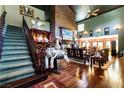 Spacious living room with hardwood floors, large brick fireplace, and grand staircase at 362 Rainbow Canyon Blvd, Las Vegas, NV 89124