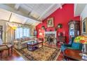 Cozy living room featuring a brick fireplace, hardwood floors, vaulted ceilings, and plenty of natural light at 3940 Spencer St, Las Vegas, NV 89119
