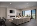 Spacious living room with a fireplace and expansive windows showcasing city views at 410 Tranquil Peak Ct, Henderson, NV 89012