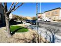 Residential street view with artificial turf and parked cars at 6329 Kitamaya St, North Las Vegas, NV 89031