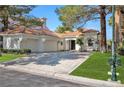 Beautiful home with a tile roof, two-car garage, and landscaped yard at 8924 Rainbow Ridge Dr, Las Vegas, NV 89117