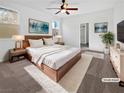 Virtually staged main bedroom with wood platform bed and ensuite bathroom at 10375 Beallsville St, Las Vegas, NV 89141