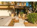 Front entry with stairs, landscaping, and a covered porch at 10744 Balsam Creek Ave, Las Vegas, NV 89144