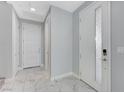 Bright entryway with white doors and marble tile floors at 11377 Gravitation Dr, Las Vegas, NV 89135