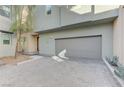 Gray attached garage with paved driveway at 11377 Gravitation Dr, Las Vegas, NV 89135