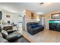 Living room features leather furniture and a view into kitchen at 1215 Ferguson Ave, North Las Vegas, NV 89030