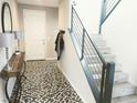 Modern entryway with patterned floor, staircase, and console table at 12815 Alcores St, Las Vegas, NV 89141