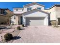 Two-story house with attached garage and brick driveway at 12815 Alcores St, Las Vegas, NV 89141