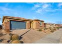 Modern single story home with gray garage door and stone accents at 1282 Paseo Del Oso Ln, Henderson, NV 89002