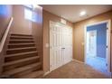 Upstairs hallway with carpet, doors to bedrooms and bathroom, and staircase at 1525 Spiced Wine Ave # 23103, Henderson, NV 89074