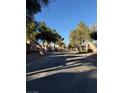 Residential street lined with trees and homes at 1804 Discus Dr, Las Vegas, NV 89108