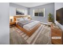 Virtually staged main bedroom with light wood furniture and gray walls at 2080 Karen Ave # 49, Las Vegas, NV 89169