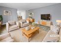 Virtually staged living room featuring light beige furniture and wood flooring at 2080 Karen Ave # 49, Las Vegas, NV 89169