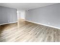 Living room with light gray walls and wood-look flooring at 2080 Karen Ave # 49, Las Vegas, NV 89169