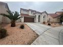 Two-story house with brown garage door and palm trees at 2104 Fountain View Dr, Las Vegas, NV 89134