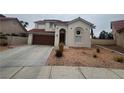 Two-story house with brown garage door and desert landscaping at 2104 Fountain View Dr, Las Vegas, NV 89134