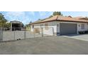 Attached garage with chain link fence and separate shed at 2250 Xenia Ave, Pahrump, NV 89048