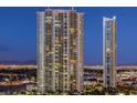 Night view of two modern highrise buildings with city lights in the background at 322 Karen Ave # 1001, Las Vegas, NV 89109