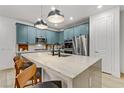 Modern kitchen with blue cabinets and a large marble island at 355 Purple Sandpiper St, Las Vegas, NV 89138