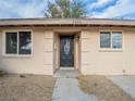 House exterior featuring a black front door and light beige wall at 3644 San Pascual Ave, Las Vegas, NV 89115