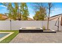 Modern rectangular fire pit with stone and paver patio at 3940 Colonial Field Ave, North Las Vegas, NV 89031