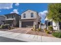 Two-story house with gray exterior, brown garage door, and landscaped front yard at 406 Misterioso St, Henderson, NV 89011