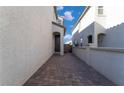 Brick paved walkway between two light gray houses at 406 Misterioso St, Henderson, NV 89011