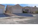 Front view of a single story house with a two car garage at 4613 Golden Palomino Ln, North Las Vegas, NV 89032