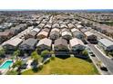 Aerial view of a community with many houses and a pool at 4710 Frasers Owl Ave # 103, North Las Vegas, NV 89084