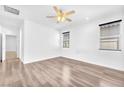 Spacious bedroom with ceiling fan, wood-look floors and natural light at 5640 Akula Bay St, North Las Vegas, NV 89081