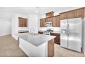 Bright kitchen features granite countertops, an island with sink, and stainless steel appliances at 5640 Akula Bay St, North Las Vegas, NV 89081